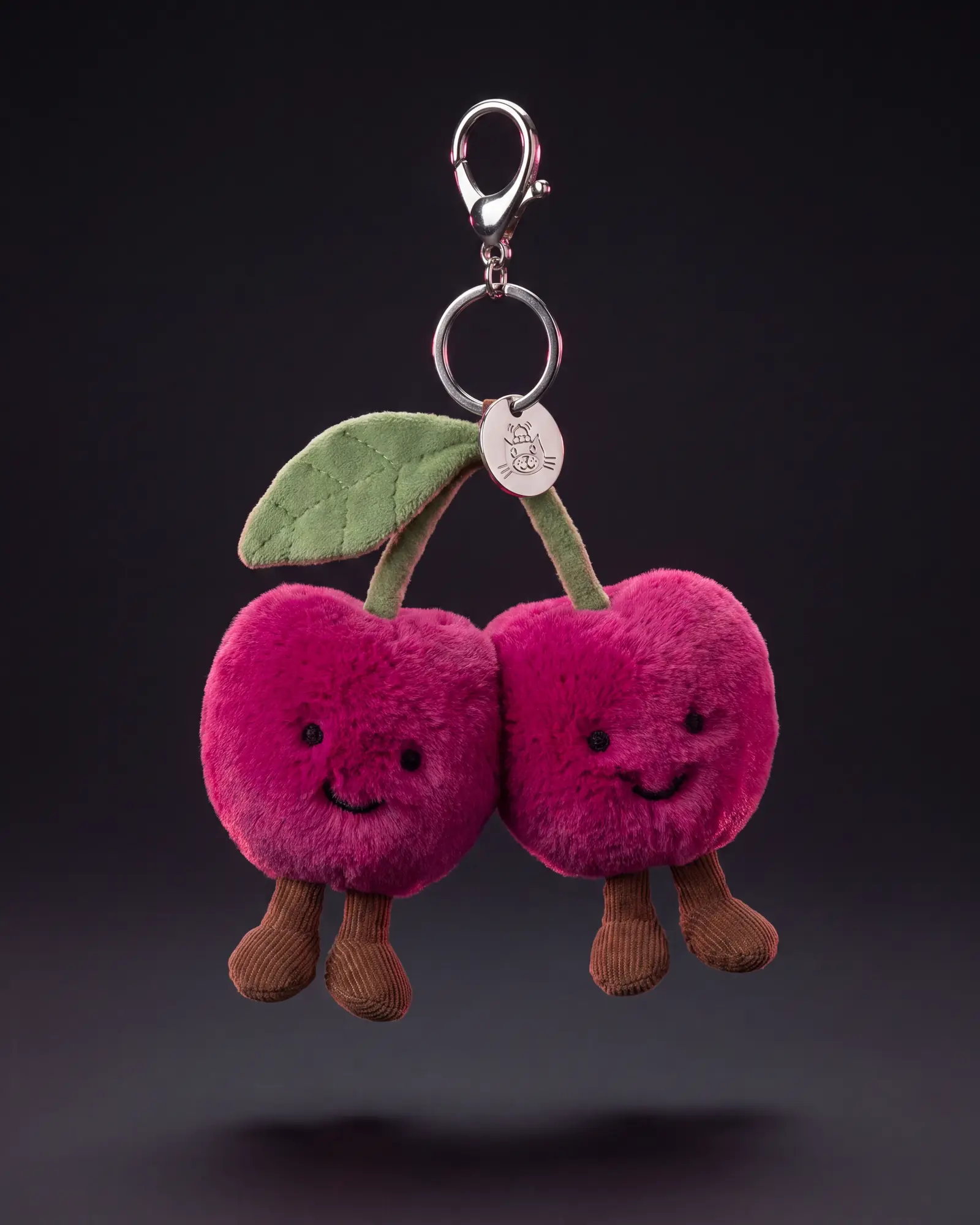 Amuseables Cherries Bag Charm on a dark studio background.