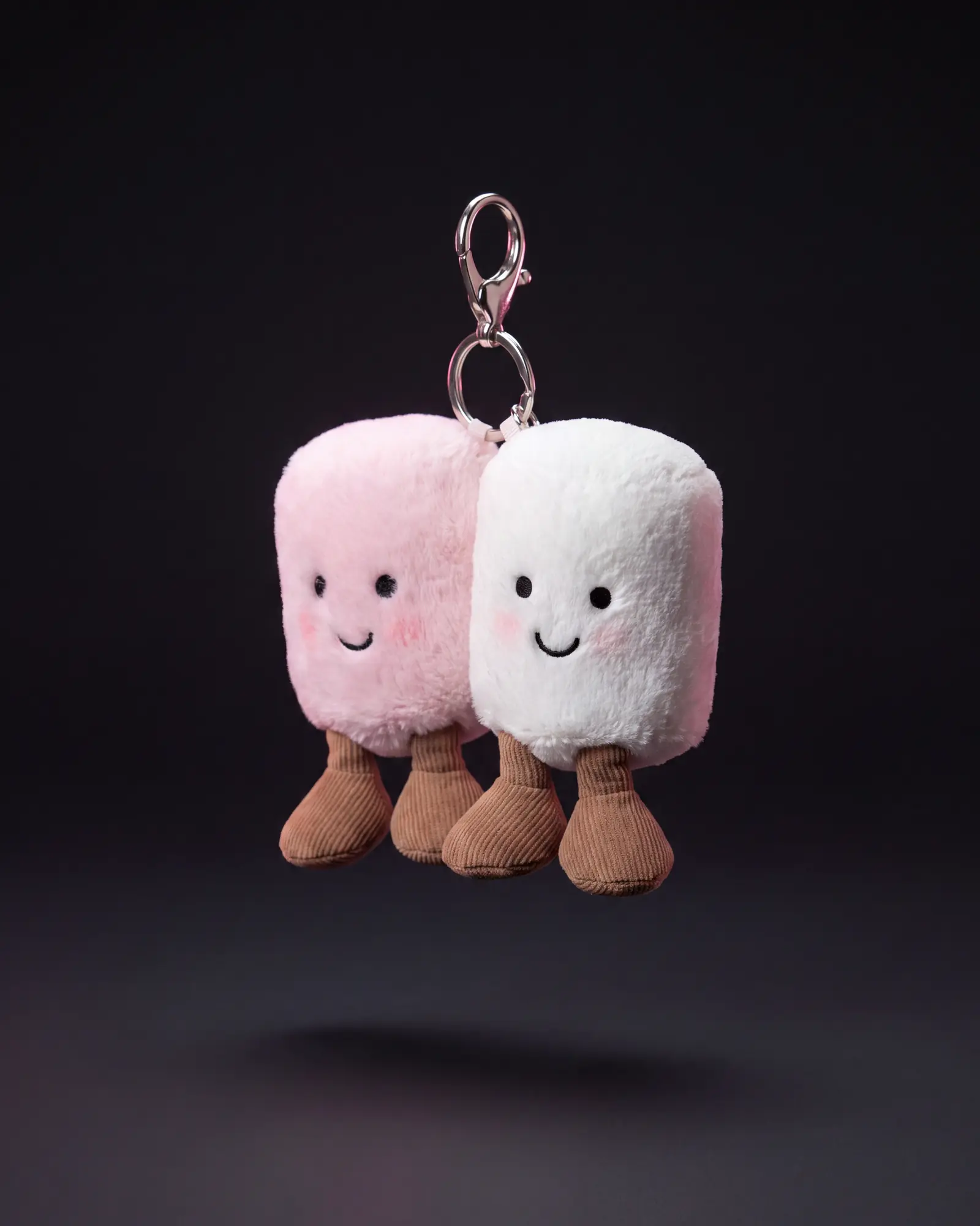 Amuseables Pair of Marshmallows Bag Charm on a dark studio background.