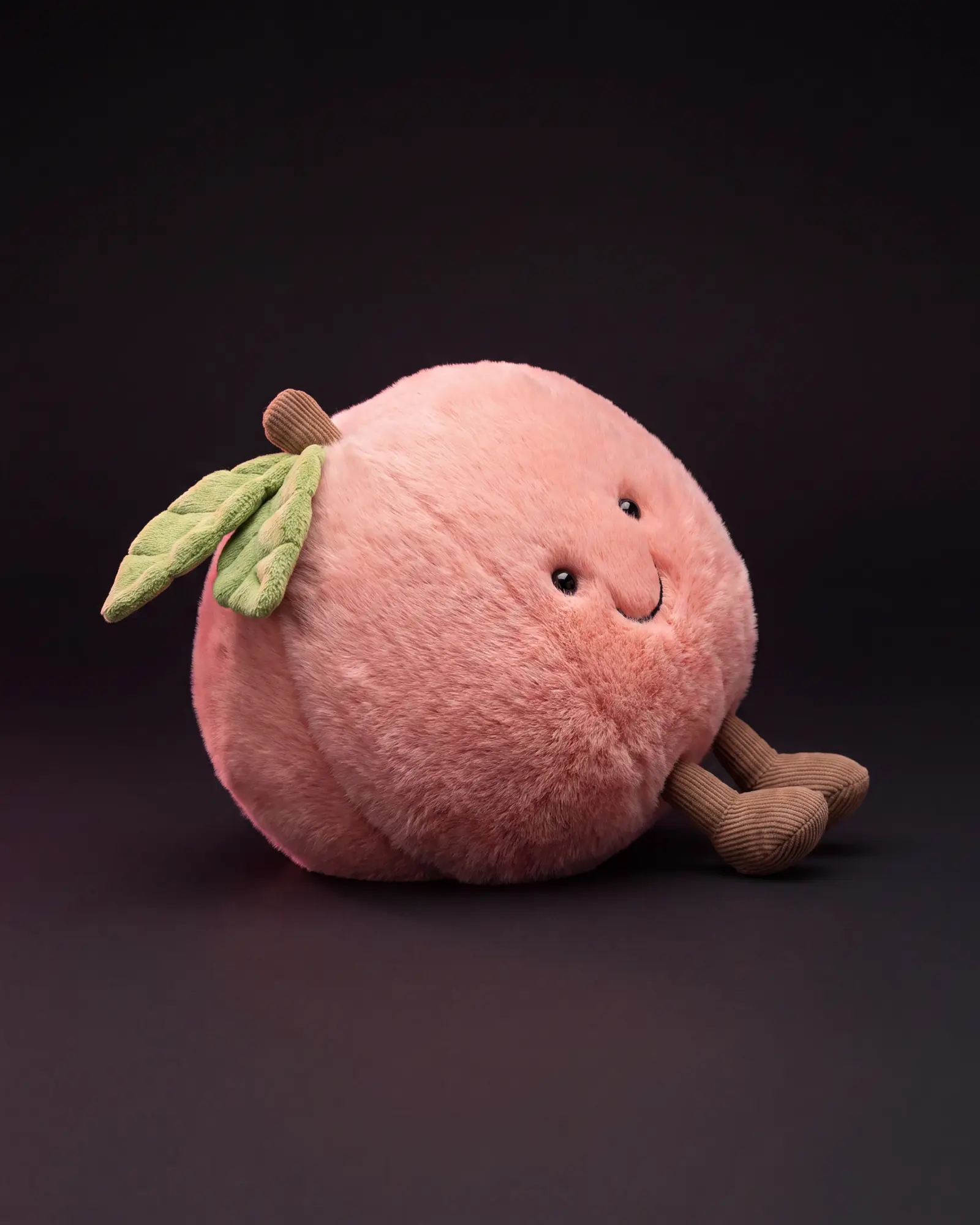 Amuseables Peach on a dark studio background.