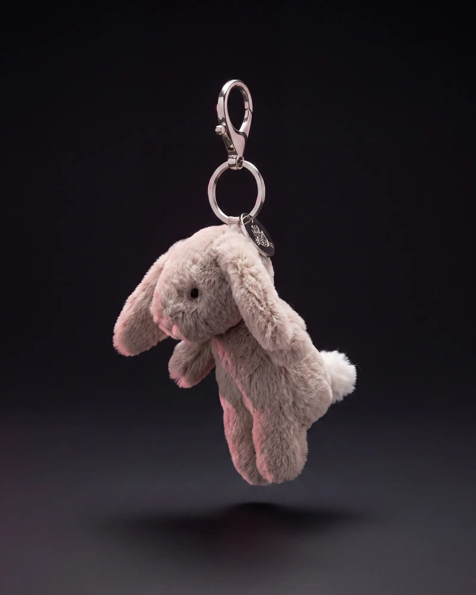 Bashful Bunny Beige Bag Charm on a dark studio background.