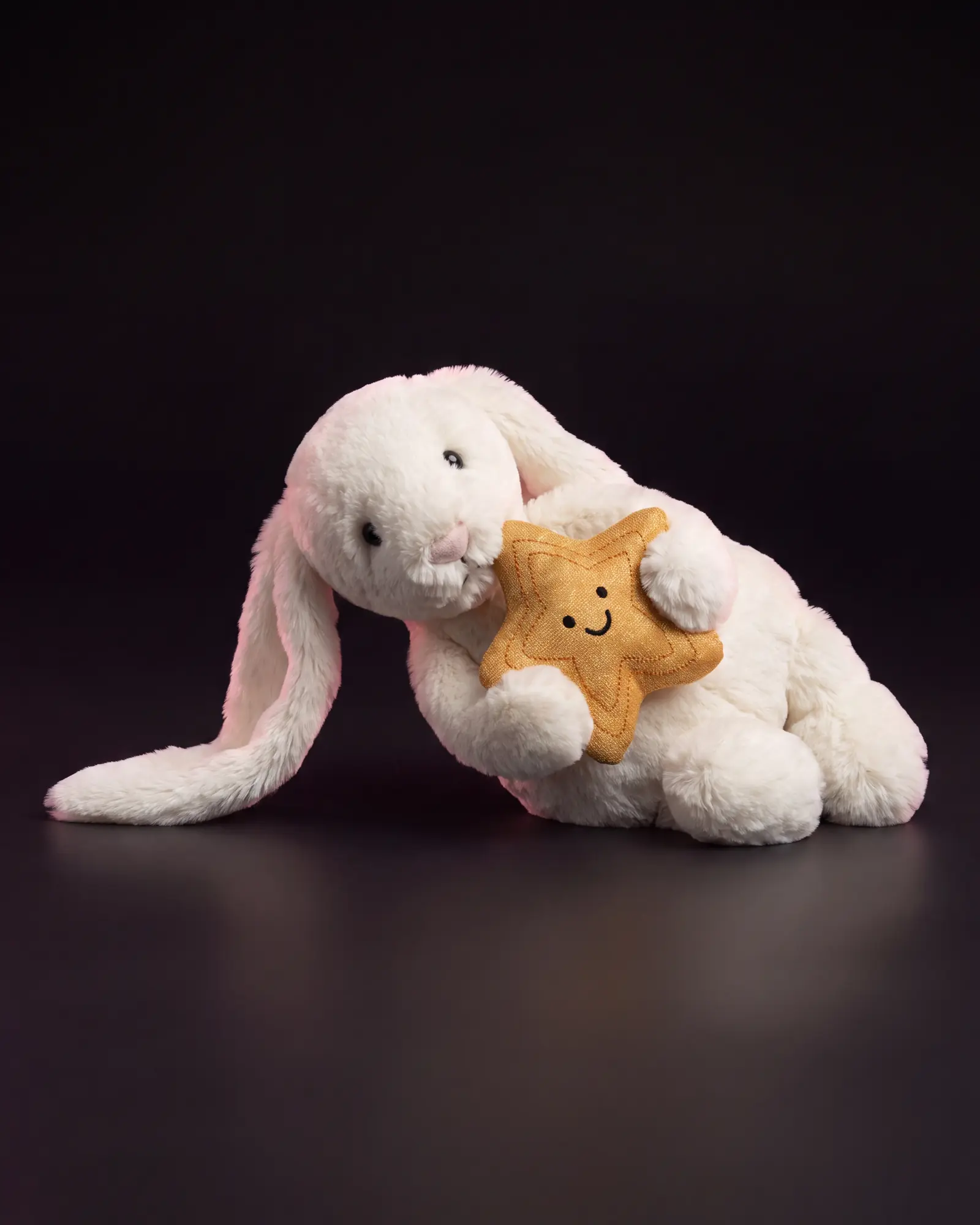 Cream Bunny with Star on a dark studio background.
