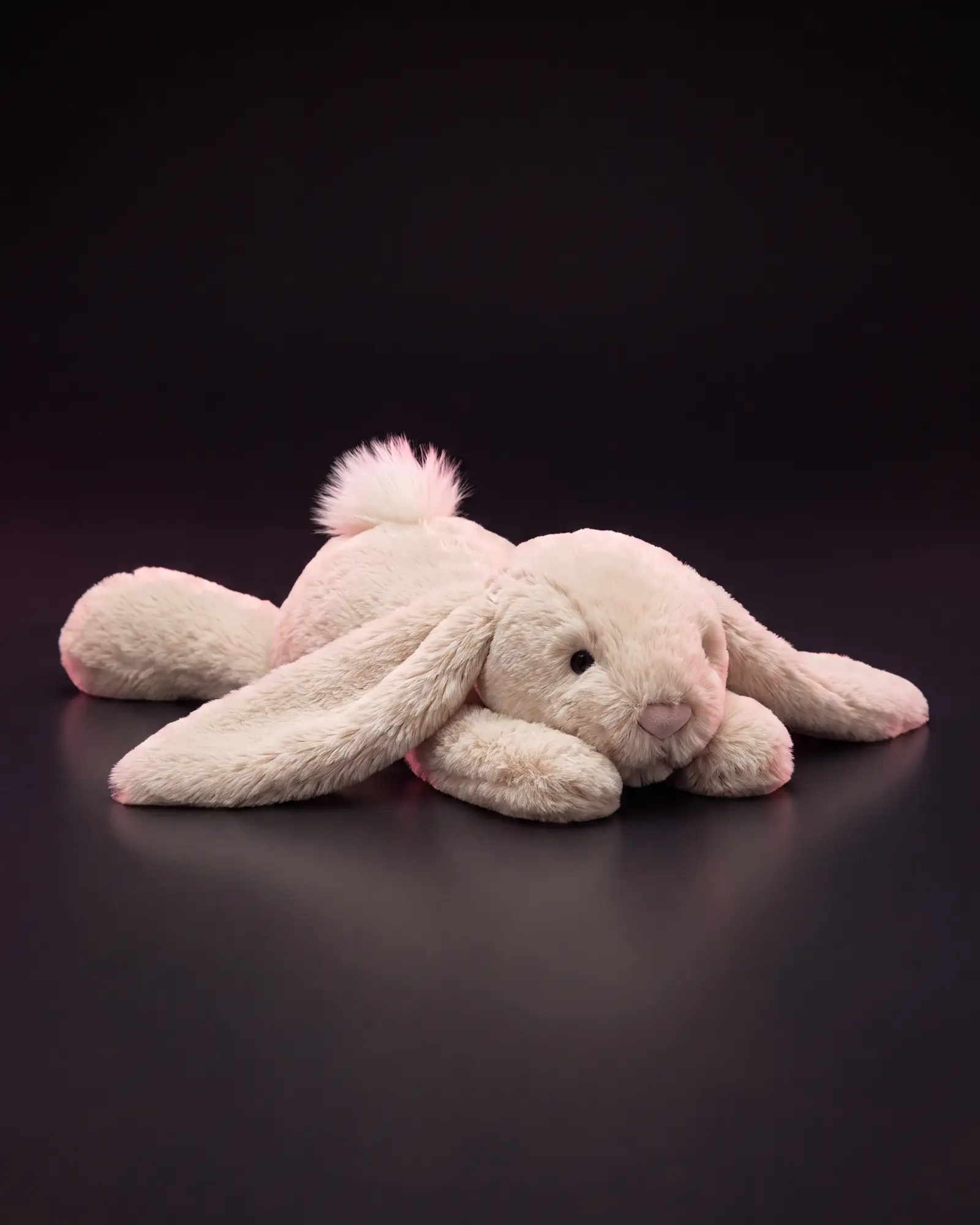 Smudge Rabbit on a dark studio background.